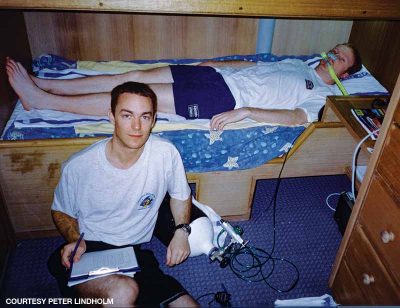 Lindholm uses a simple device for extending oxygen supply to a diver during field studies on a dive boat in the Coral Sea.